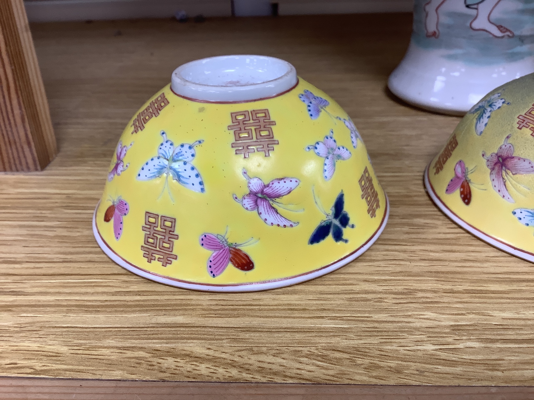 A pair of Chinese yellow ground porcelain small bowls, enamelled with butterflies, diameter 11cm